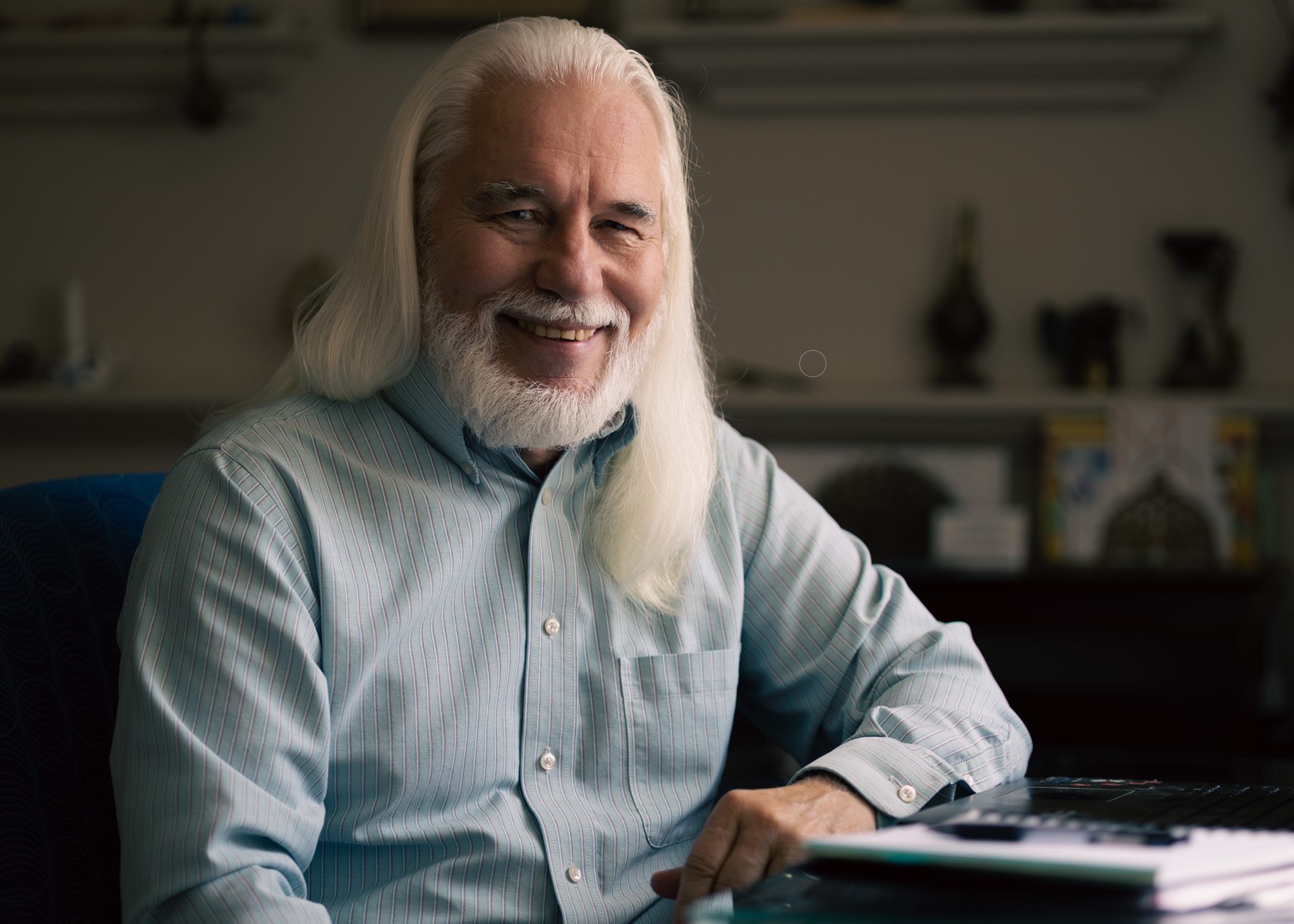 Paul Pennington sitting at table smiling